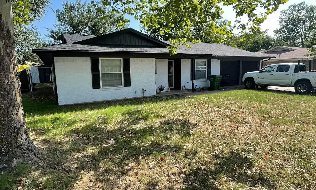 Professional roofing crew working on a residential roof in North Olmsted